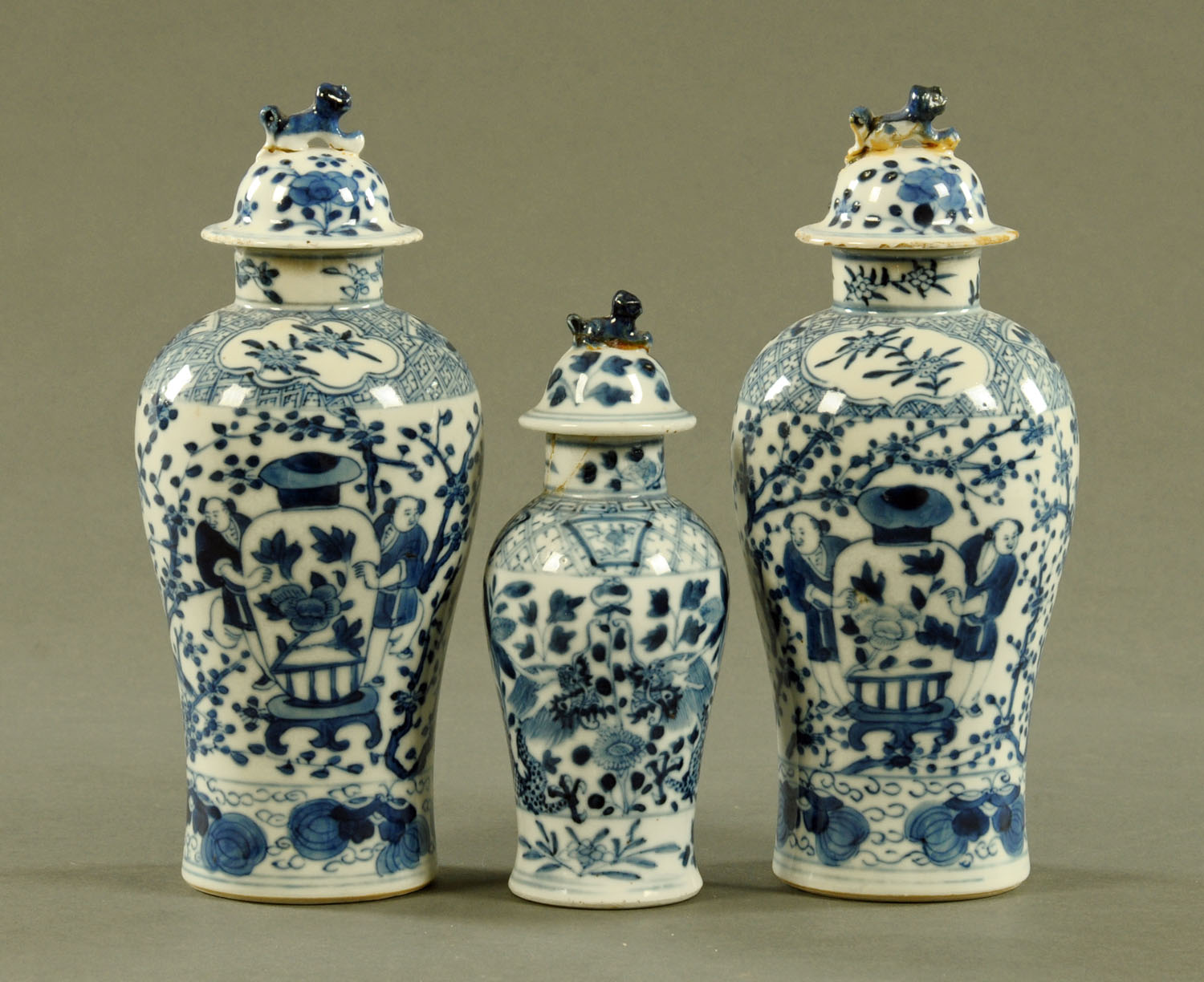 A pair of Chinese blue and white lidded vases, and another similar but smaller,