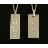 Two silver ingots, each with chain.