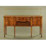 A Regency style mahogany sideboard with brass gallery and serpentine front,