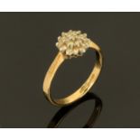 A 9 ct gold diamond daisy cluster ring, Size L/M.