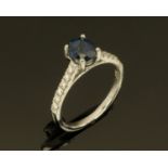 An 18 ct gold sapphire and diamond ring, sapphire +/- 1.46 carats, diamonds +/- 0.24 carats, size N.