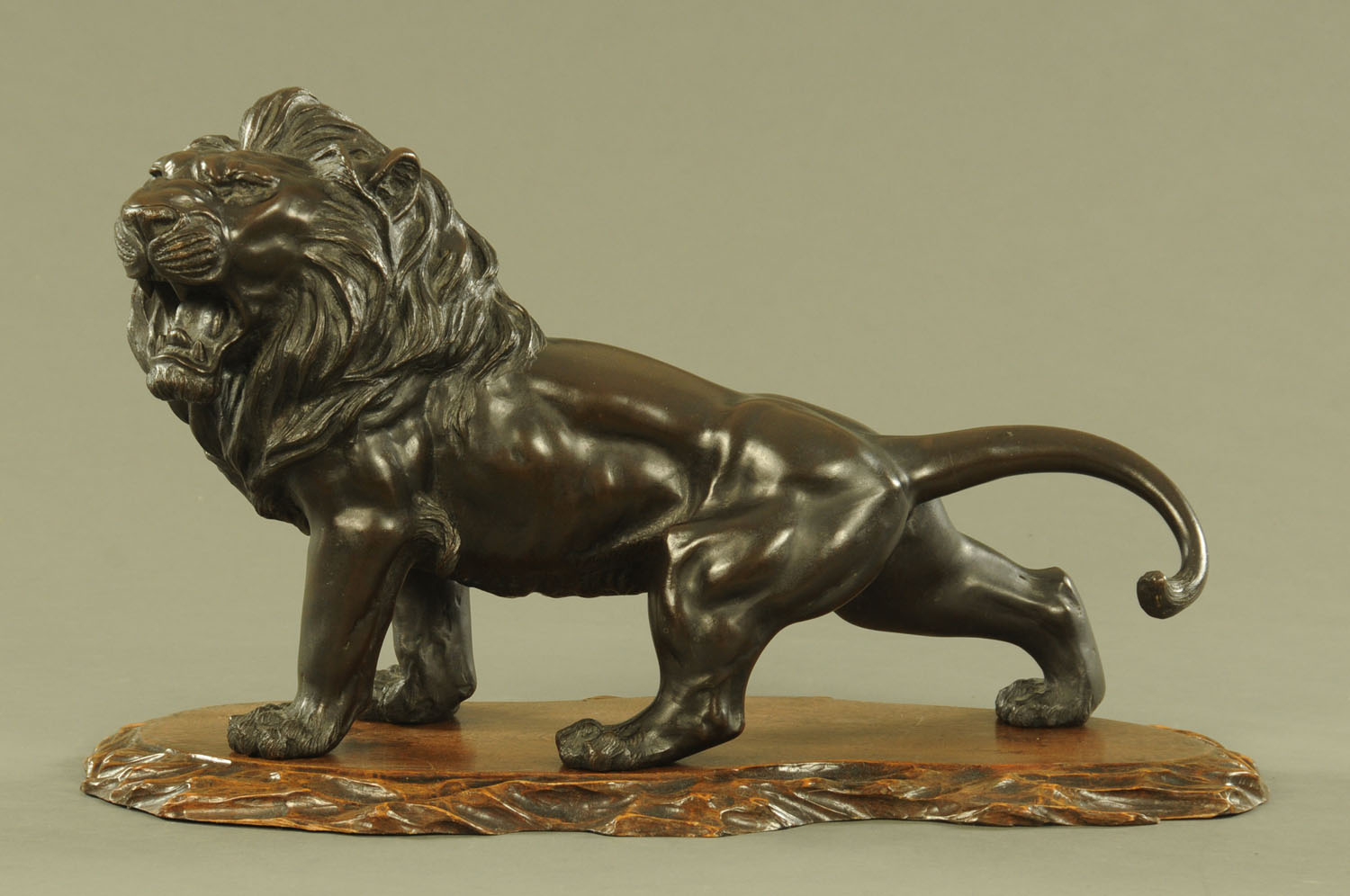 A large Chinese bronze prowling lion,