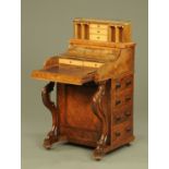 A Victorian walnut piano front Davenport, with rise and fall stationery compartment,