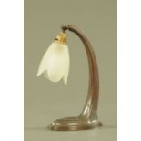 An Art Nouveau metal lamp, with frosted glass shade. Height 31 cm.
