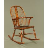 A Titchmarsh and Goodwin Windsor style rocking chair. Width across arms 58 cm, height 98 cm.