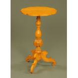 A Victorian style satinwood shaped occasional table, with turned columns and three silhouette legs.