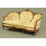 A Victorian style wooden framed settee, foliate and scroll carved,