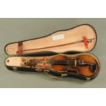 A vintage Czechoslovakian half size violin. Length of back 12 3/8", cased and with bow.