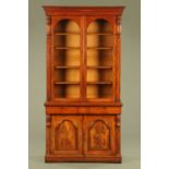 A Victorian mahogany bookcase on cupboard in two sections,