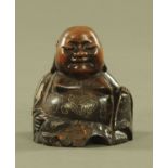 A Chinese wooden metal inlaid Buddha figure. Height 13 cm.