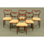A set of six Victorian rosewood dining chairs, each with bowed top rail, carved mid rail,