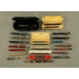 A collection of vintage fountain pens, including Burnham propelling pencil,