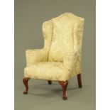 A late 19th/early 20th century Queen Anne style wing easy chair,