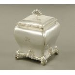 An Edward VII silver square tea caddy, with waisted body and scroll feet,