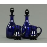 A pair of Regency Bristol blue glass decanters,