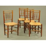 A set of four 19th century rush seated spindle backed country kitchen dining chairs.