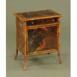 A Victorian bamboo cabinet, with drawer and cupboard and with lacquered front panel.