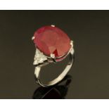 An 18 ct gold ruby and diamond ring, ruby +/- 11.45 carats, size M/N (see illustration).