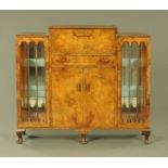 An Art Deco walnut veneered cocktail cabinet,