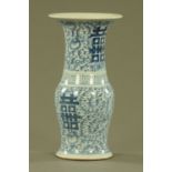 A 19th century Chinese blue and white vase, with flared rim and four character mark to base.