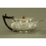A George III silver teapot probably by Solomon Hougham London 1805, later foliate embossed.