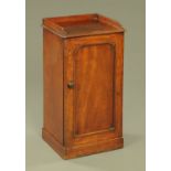 A Victorian mahogany bedside cabinet, with three quarter gallery, single door and pedestal base.