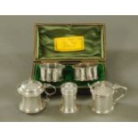 A matched three piece silver condiment set, different makers, different marks,