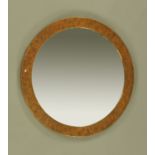 A circular copper framed mirror circa 1920, with bevelled glass. Frame diameter 73 cm.