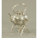 A Victorian plated spirit kettle on stand, foliate engraved and with stick form stand.