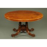 A Victorian walnut dining table with well figured top with moulded edge and four turned and carved