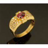 An 18 ct yellow gold ruby and diamond set ring, ruby +/- 0.95 carats, size L/M.