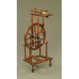 A 19th century spinning wheel, with typical turned construction.