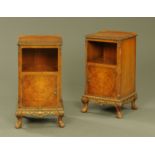 A pair of walnut bedside cabinets, with carved edges, canted angles,