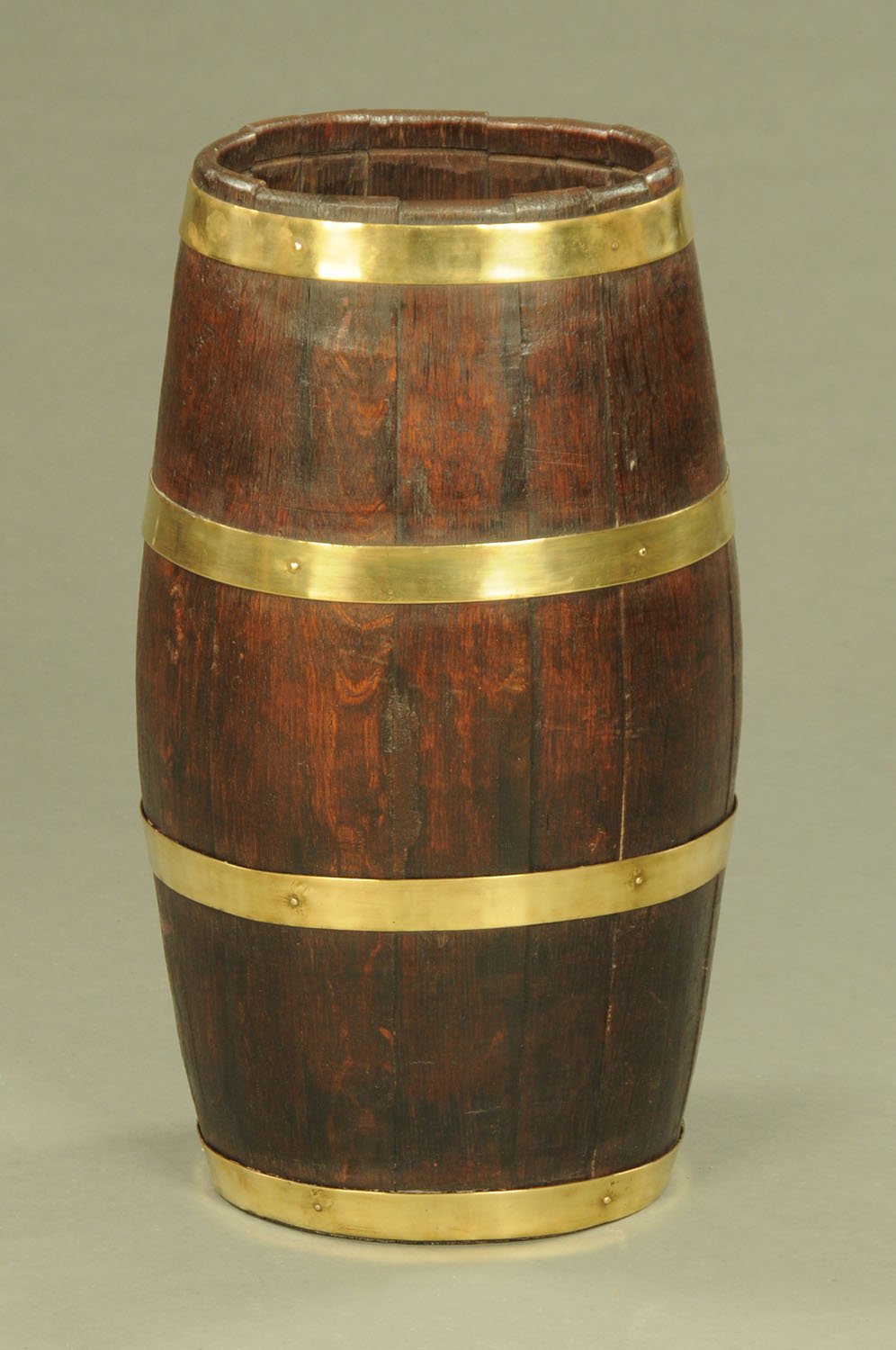 An oak barrel form brass bound stick stand. Height 60 cm, width across top 27 cm.