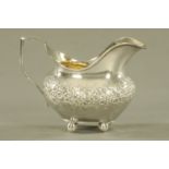 A George III silver milk jug by Alexander Hewat London 1811, raised on four ball feet. 192 grams.