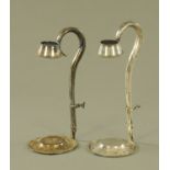 A pair of silver plated adjustable wine bottle holders.