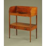 An early 19th century mahogany washstand, with tall splash back and basin aperture,