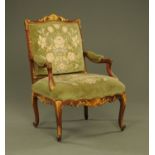 A late Victorian walnut gilt painted and upholstered open armchair,