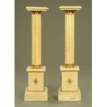 A pair of beige marble pedestals, with square tops,