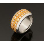 An 18 ct gold and steel puzzle ring, set with diamonds weighing +/- 1.