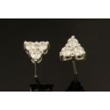 A pair of 18 ct white gold trefoil stud earrings, weighing +/- .58 carats.
