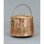 A large 19th century planished copper lidded coal or log box, with iron loop handle.