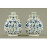 A pair of continental porcelain Pilgrim flasks, blue and white, decorated with birds and foliage,