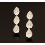 A pair of 18 ct white gold earrings, set with diamonds weighing +/- .15 carats.