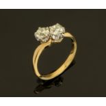An 18 ct gold two tone twist ring, set with diamonds weighing +/- .76 carats, size L.