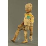 An Indian carved and turned wooden articulated male doll. Height 74 cm.