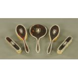 A George V silver mounted tortoiseshell five piece dressing table set, Birmingham 1918,