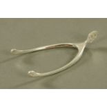 A pair of Asprey & Co wishbone pattern silver sugar tongs, 1908, length 10 cm.