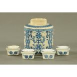 Four blue and white Meissen ointment pots, together with a cylindrical tea caddy. Height 10 cm.