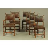 A set of two carver arm and four single leather upholstered Commonwealth style oak dining chairs,